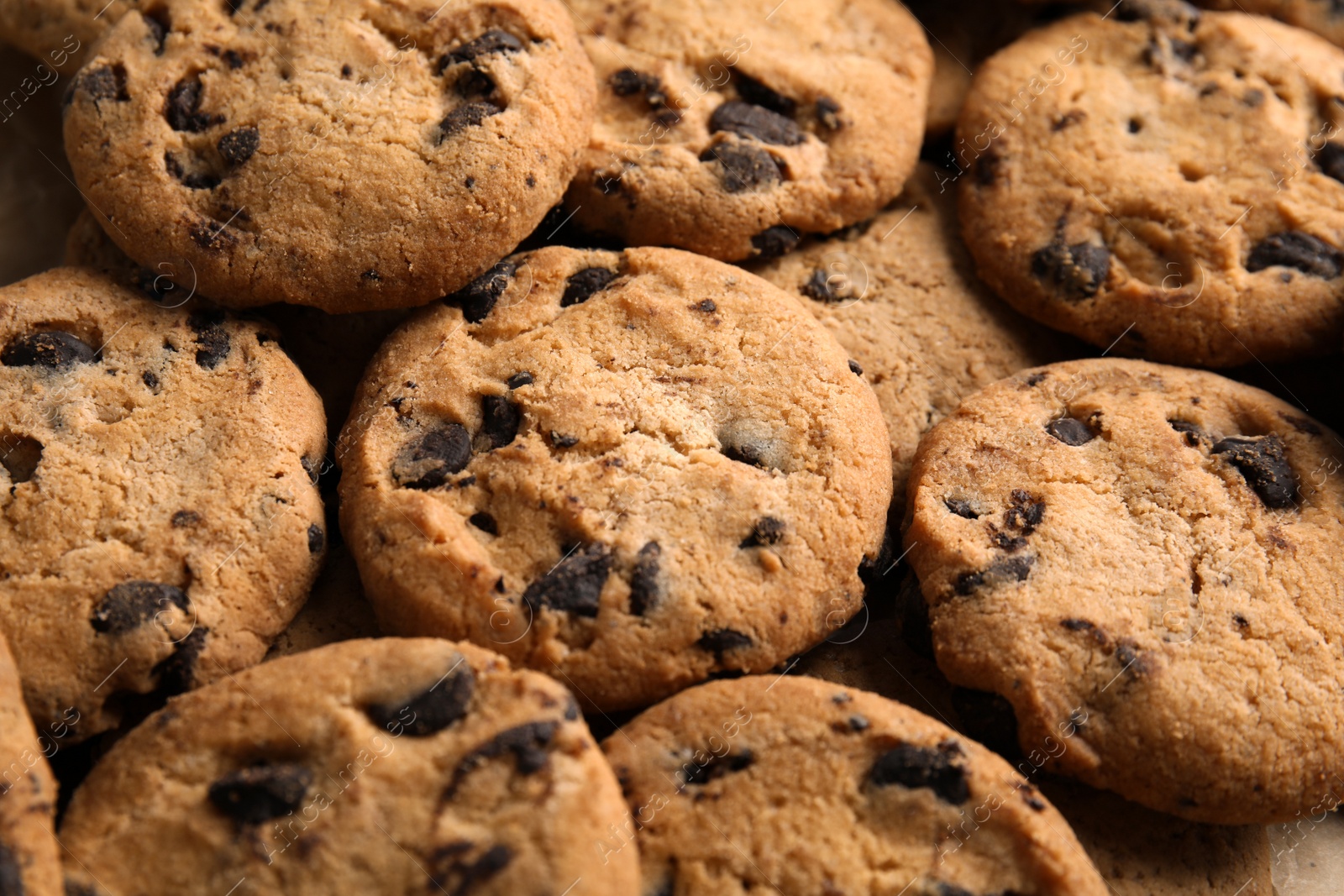 Photo of Tasty chocolate chip cookies as background, closeup