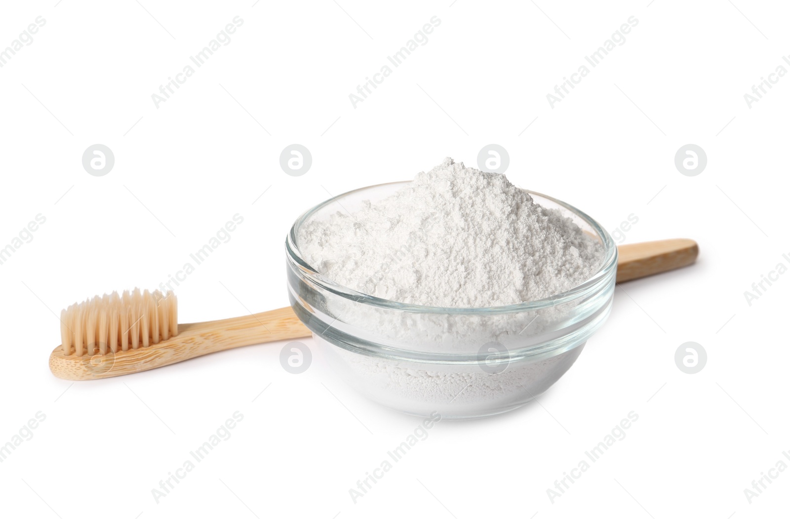 Photo of Glass bowl of tooth powder and brush on white background