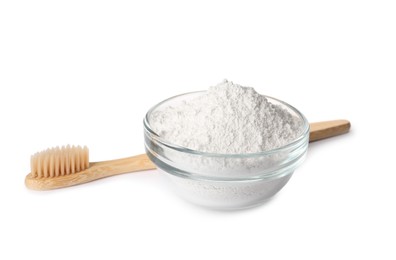 Glass bowl of tooth powder and brush on white background