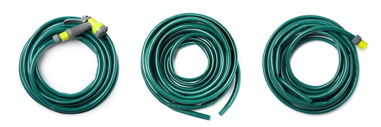 Image of Set with green rubber watering hoses on white background, top view. Banner design