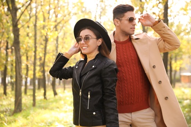 Photo of Lovely couple walking in park on autumn day