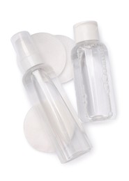 Photo of Bottles with micellar cleansing water and cotton pads on white background, top view