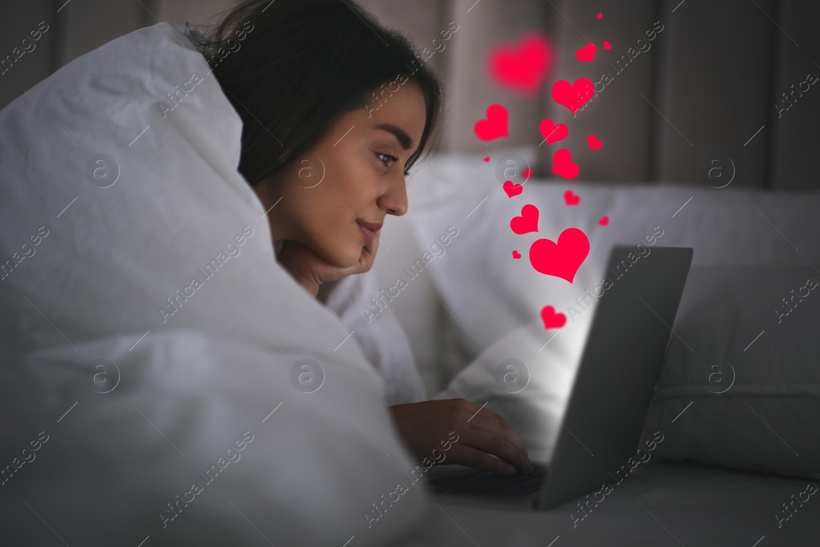 Image of Young woman visiting dating site via laptop indoors