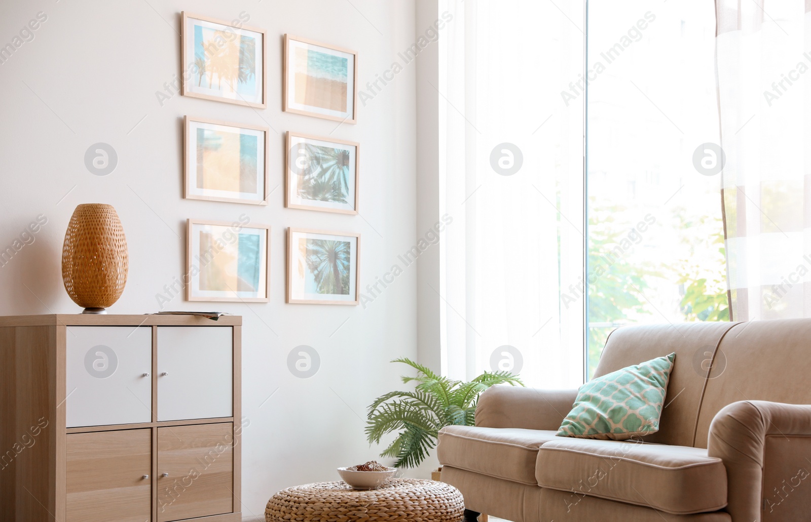 Photo of Stylish room interior with trendy furniture and pictures on wall