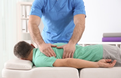 Photo of Doctor working with patient in hospital. Rehabilitation massage