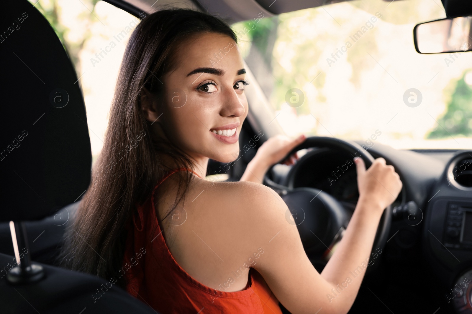 Photo of Happy young beautiful woman driving modern car