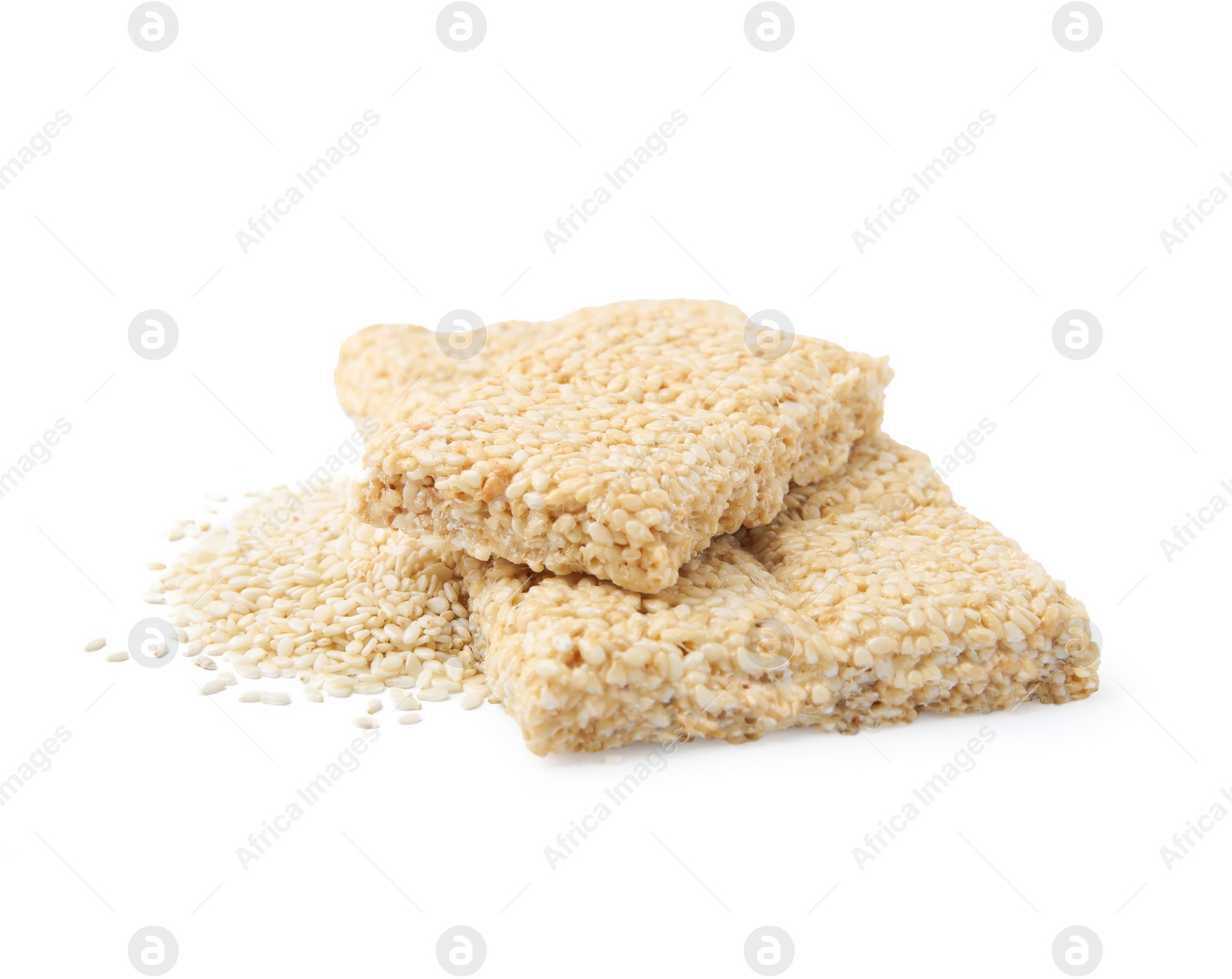 Photo of Delicious sweet kozinaki bars and sesame seeds on white background