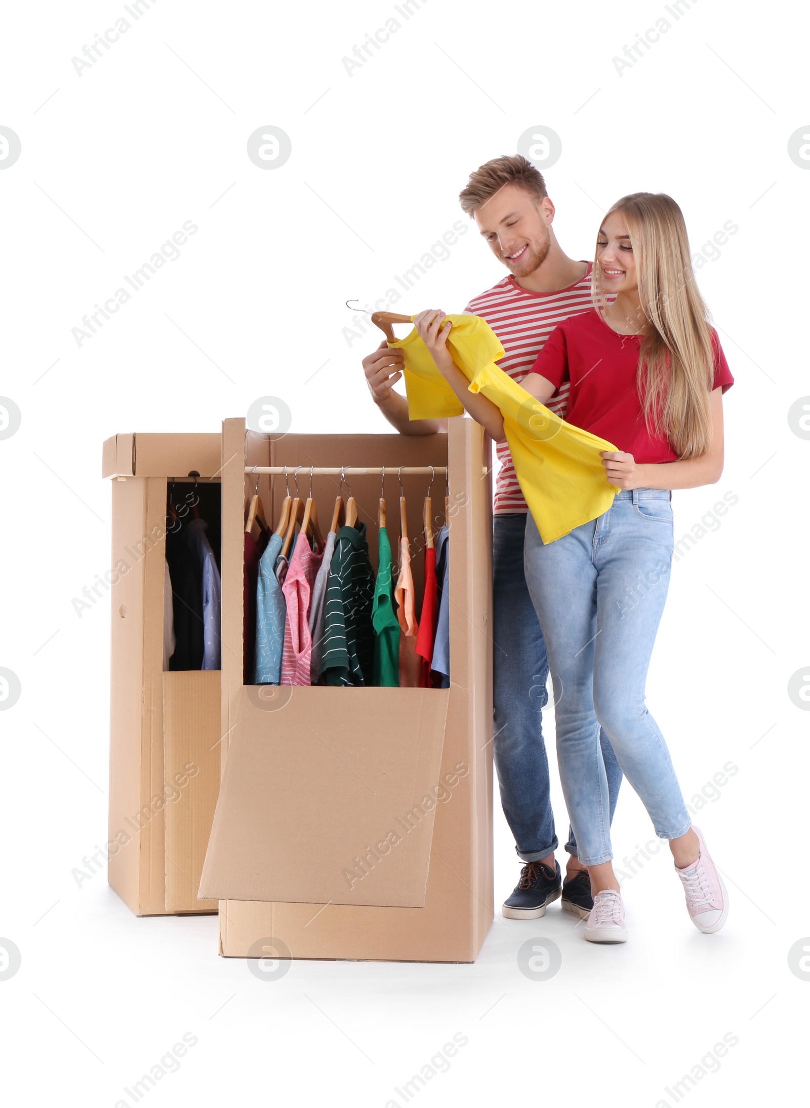 Photo of Young couple near wardrobe boxes on white background