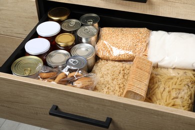 Photo of Open drawer with different products, closeup. Food donation