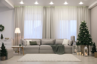 Photo of Elegant living room interior with comfortable sofa and Christmas decor