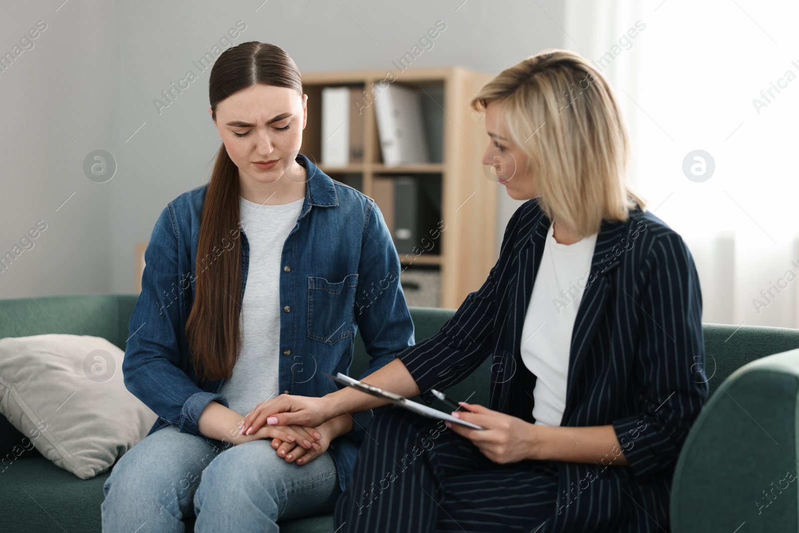 Photo of Psychotherapist working with patient on sofa in office