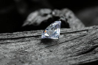 Beautiful shiny diamond on coal, closeup view