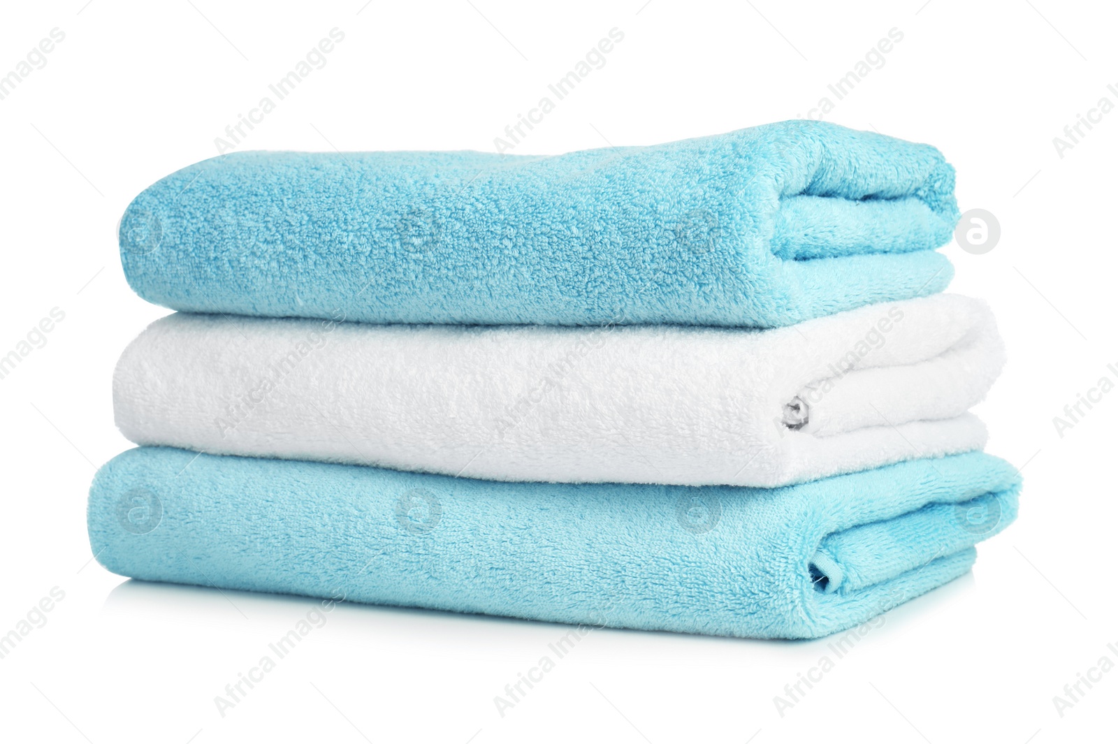 Photo of Folded soft terry towels on white background