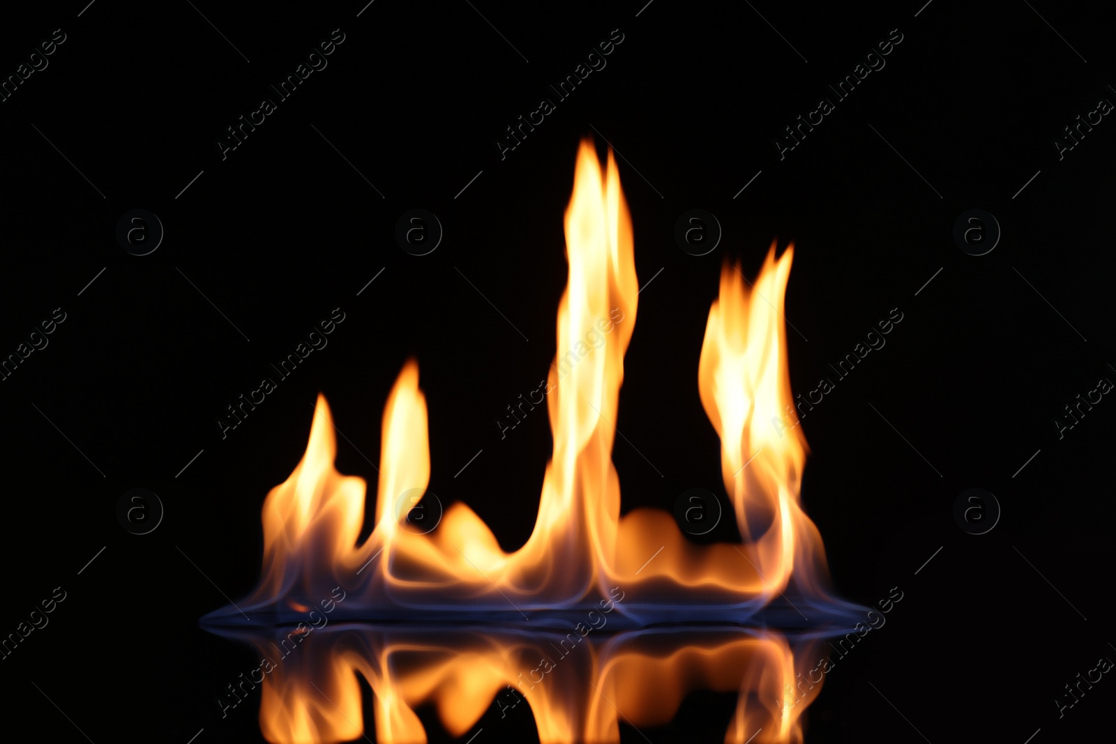 Photo of Beautiful view of flaming vodka on black background