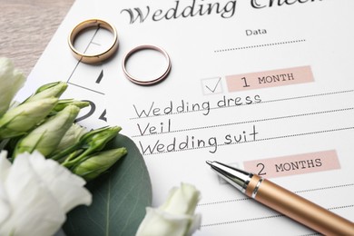 Photo of Composition with Wedding Checklist on wooden table, closeup