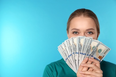 Photo of Portrait of young woman with money on color background. Space for text