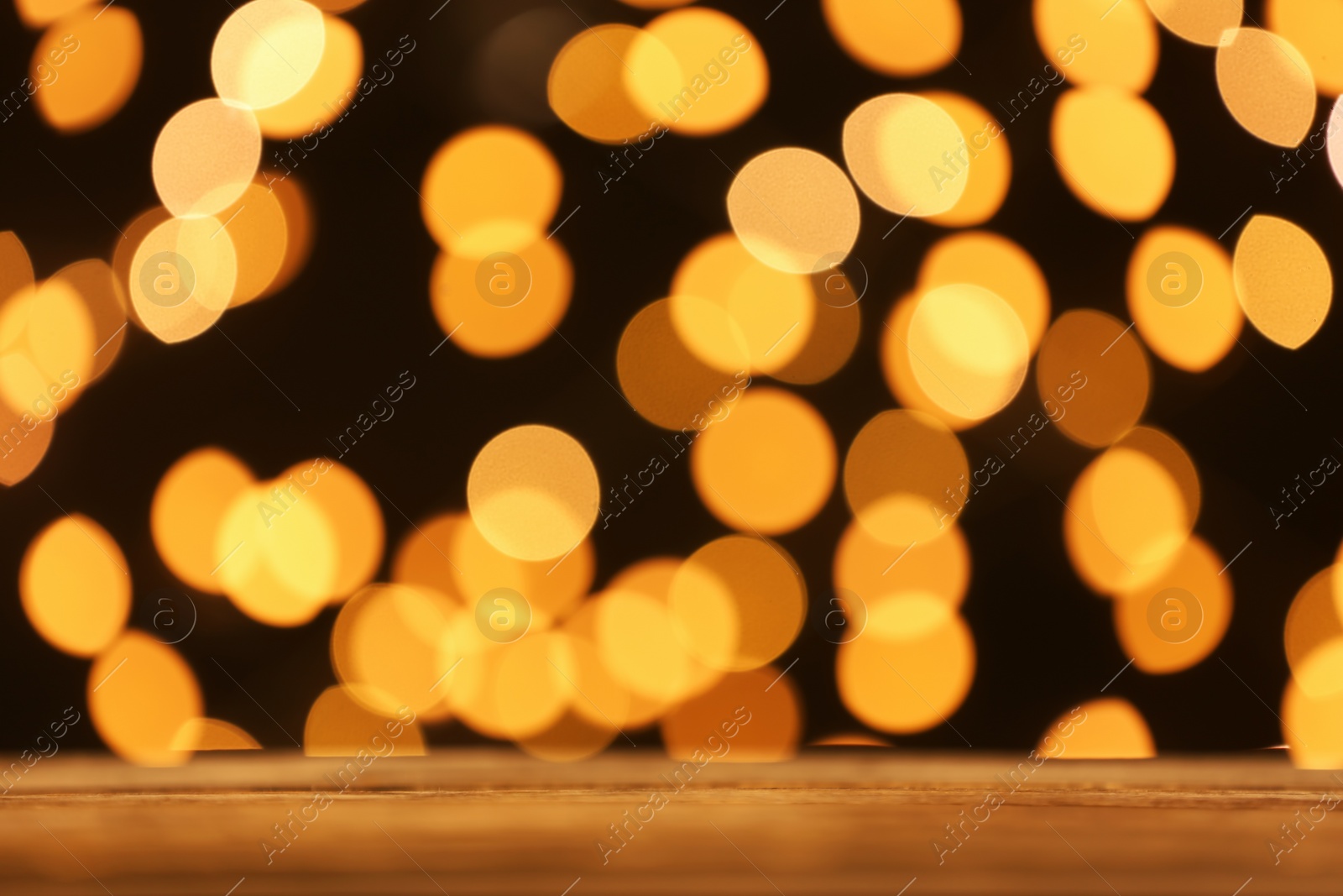 Photo of Empty table against golden bokeh background. Mockup for design