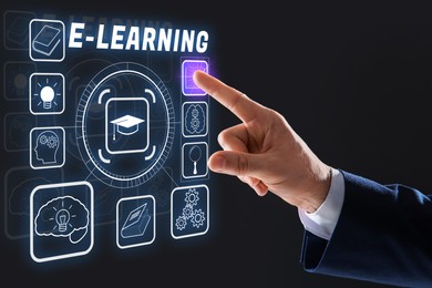 Image of E-learning. Man using virtual scheme with different icons on black background, closeup