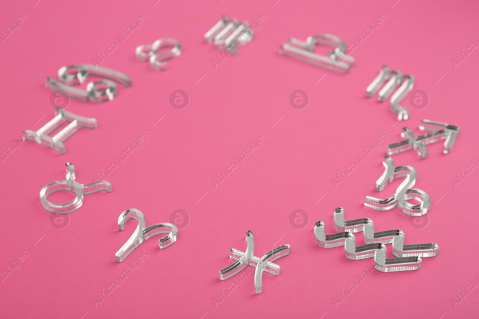 Photo of Zodiac signs on pink background. Space for text