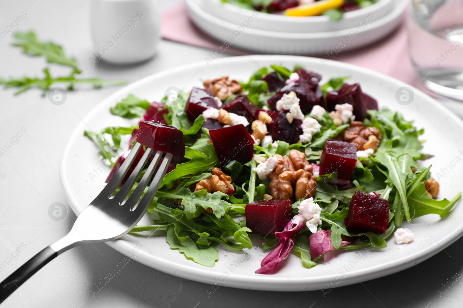 Photo of Delicious beet salad served on grey table, closeup