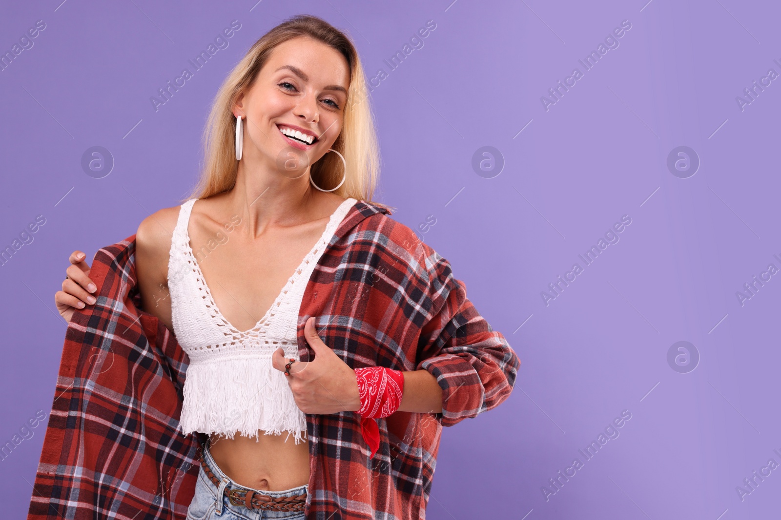 Photo of Portrait of happy hippie woman on purple background. Space for text