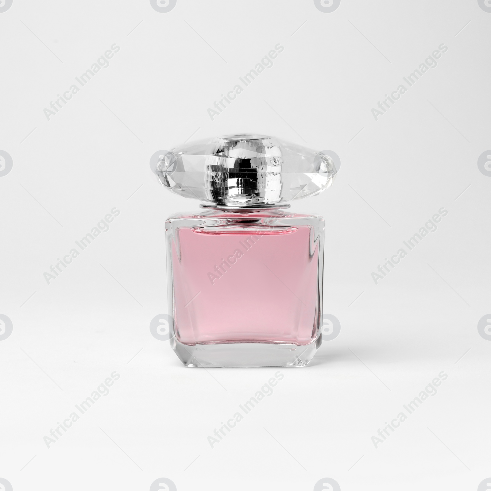 Photo of Transparent bottle of perfume on white background