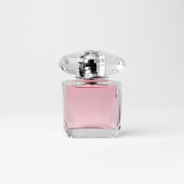 Transparent bottle of perfume on white background