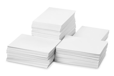 Photo of Stacks of paper sheets on white background