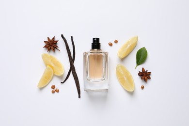Photo of Flat lay composition with bottleperfume, spices and lemon on white background