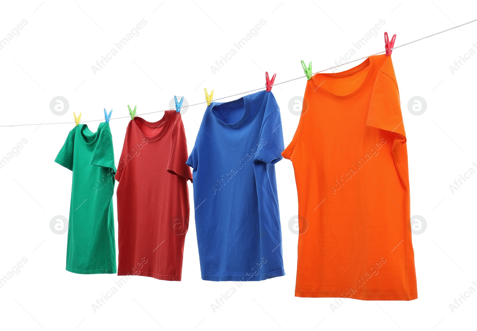 Photo of Colorful t-shirts drying on washing line isolated on white