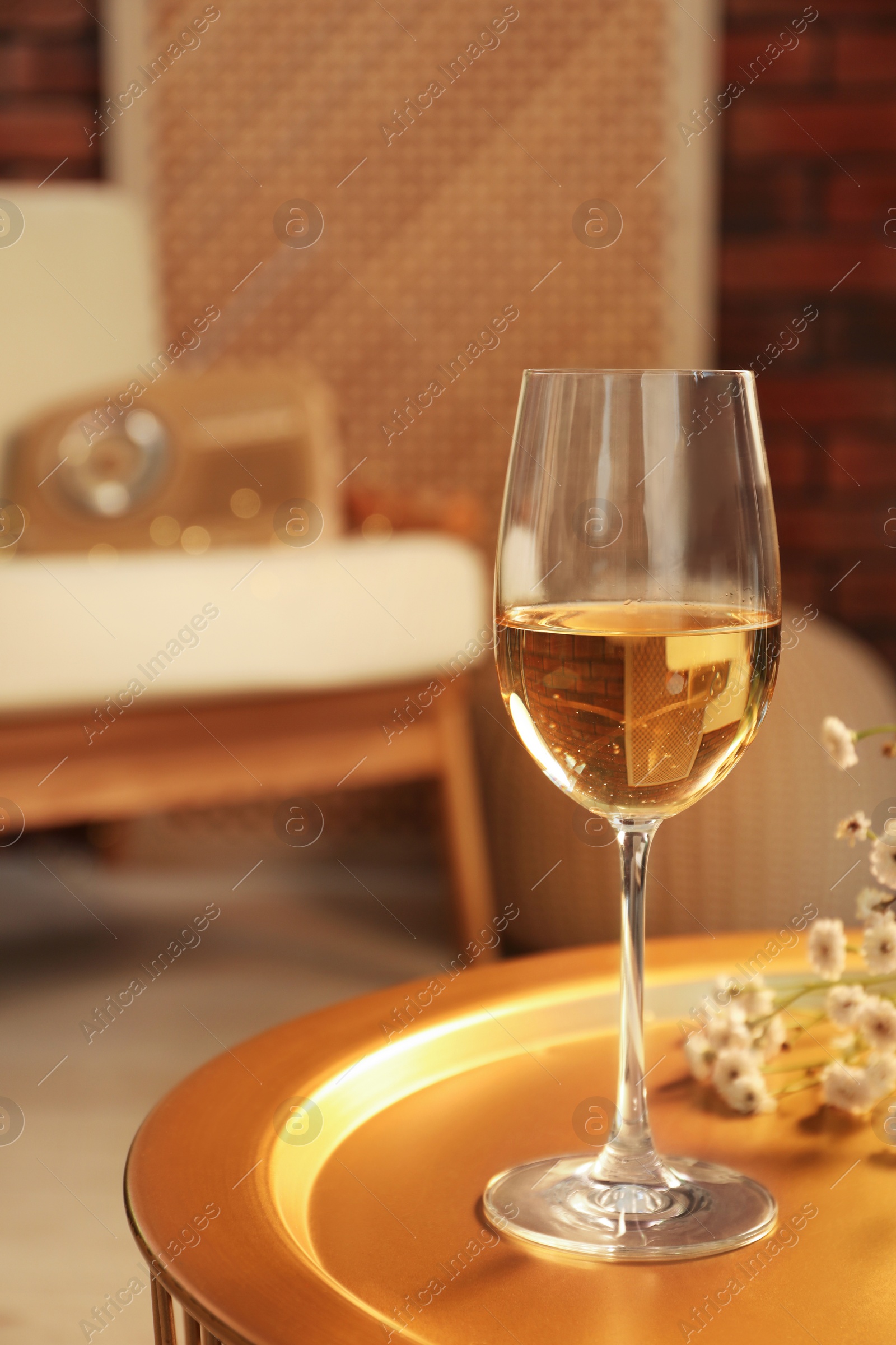 Photo of Glass of white wine on table in room, space for text. Relax at home