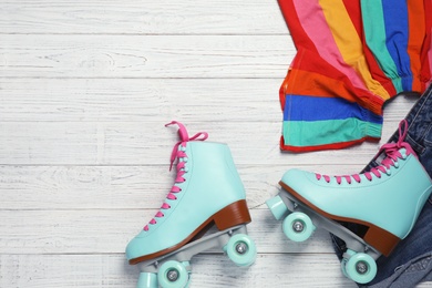 Photo of Flat lay composition with quad roller skates and space for text on wooden background