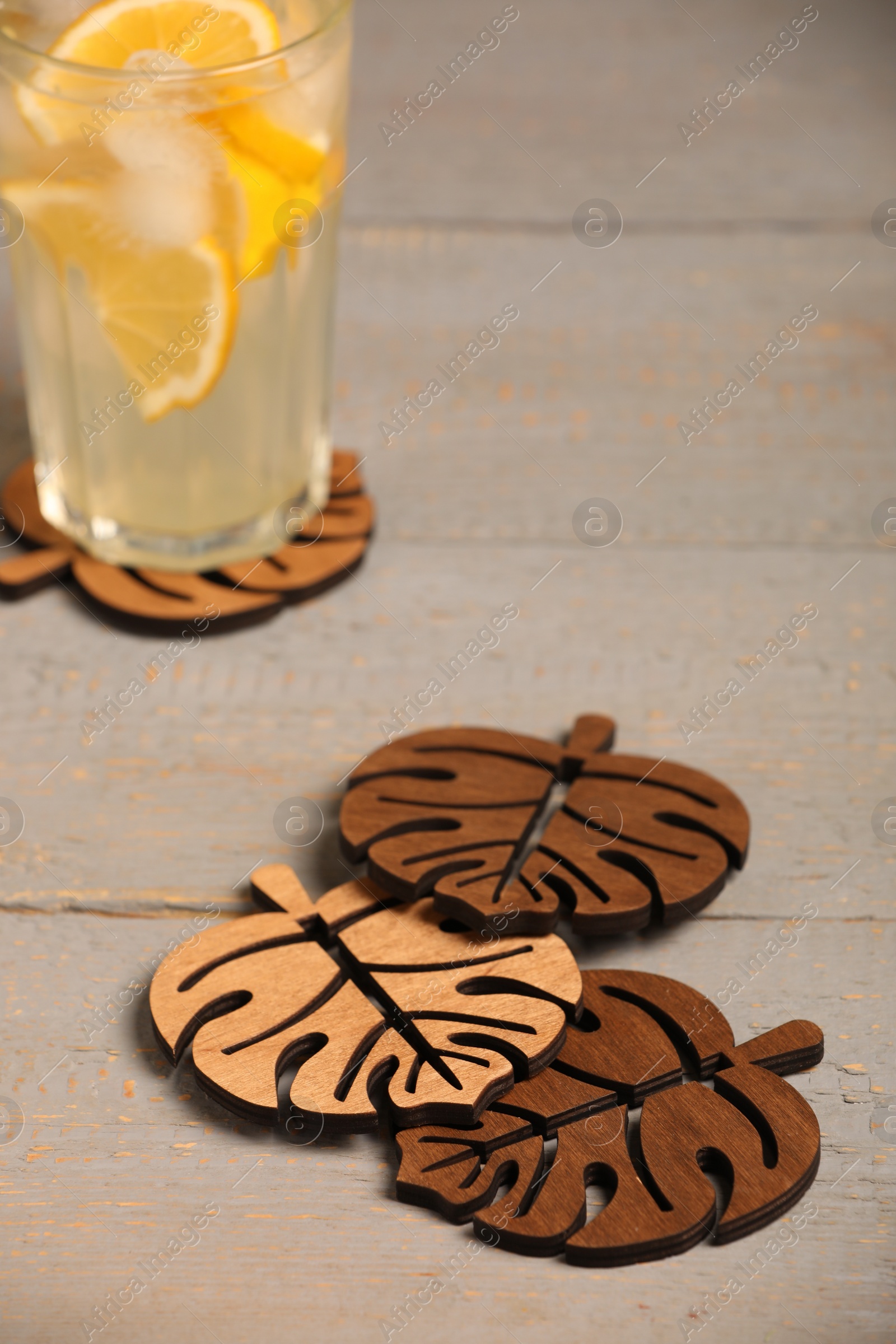 Photo of Leaf shaped cup coasters on grey wooden table