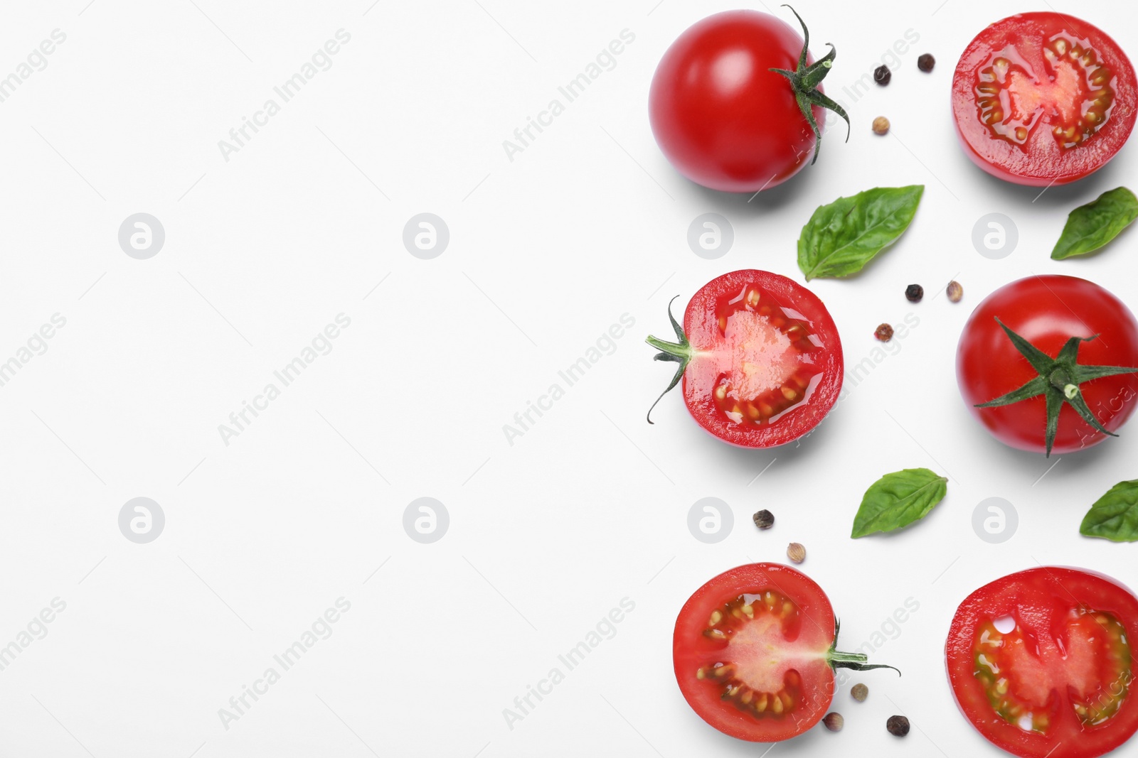 Photo of Fresh basil leaves and tomatoes on white background, flat lay. Space for text