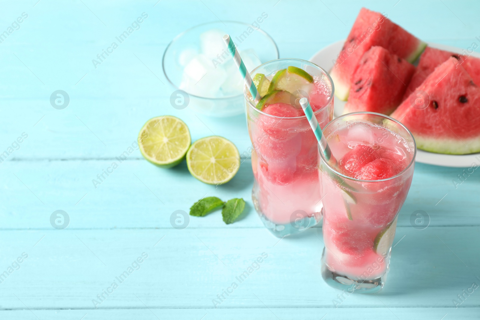 Photo of Delicious refreshing watermelon drink on blue wooden table, above view