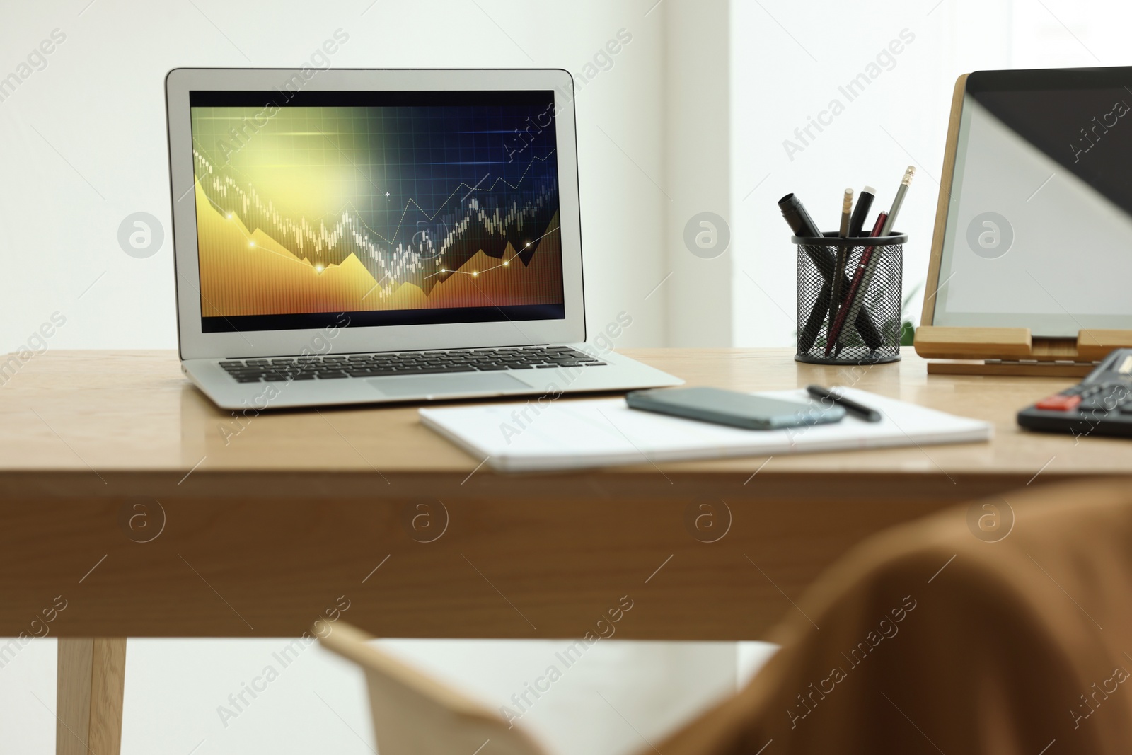 Photo of Workplace with computer, phone and stationery in office. Forex trading