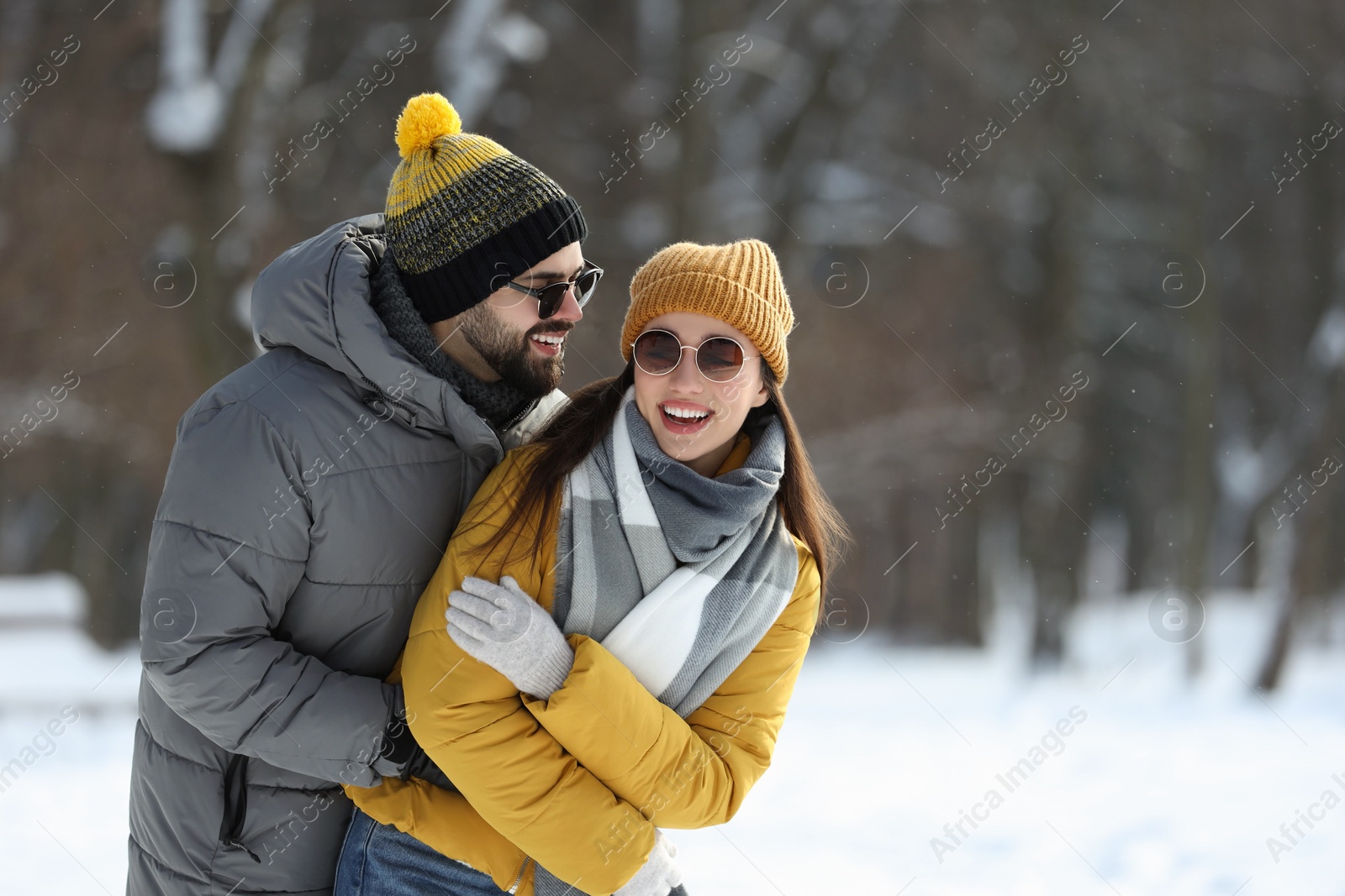 Photo of Beautiful happy couple outdoors on winter day. Space for text