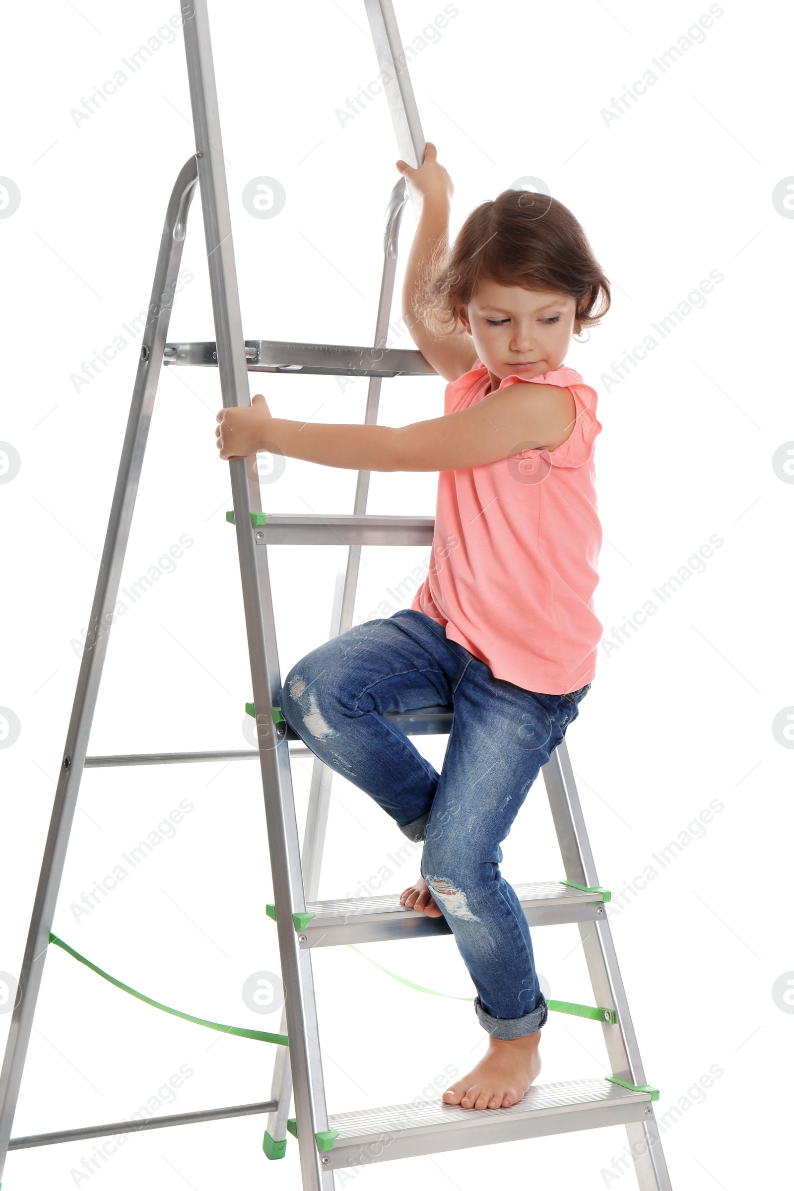 Photo of Little girl climbing up ladder on white background. Danger at home