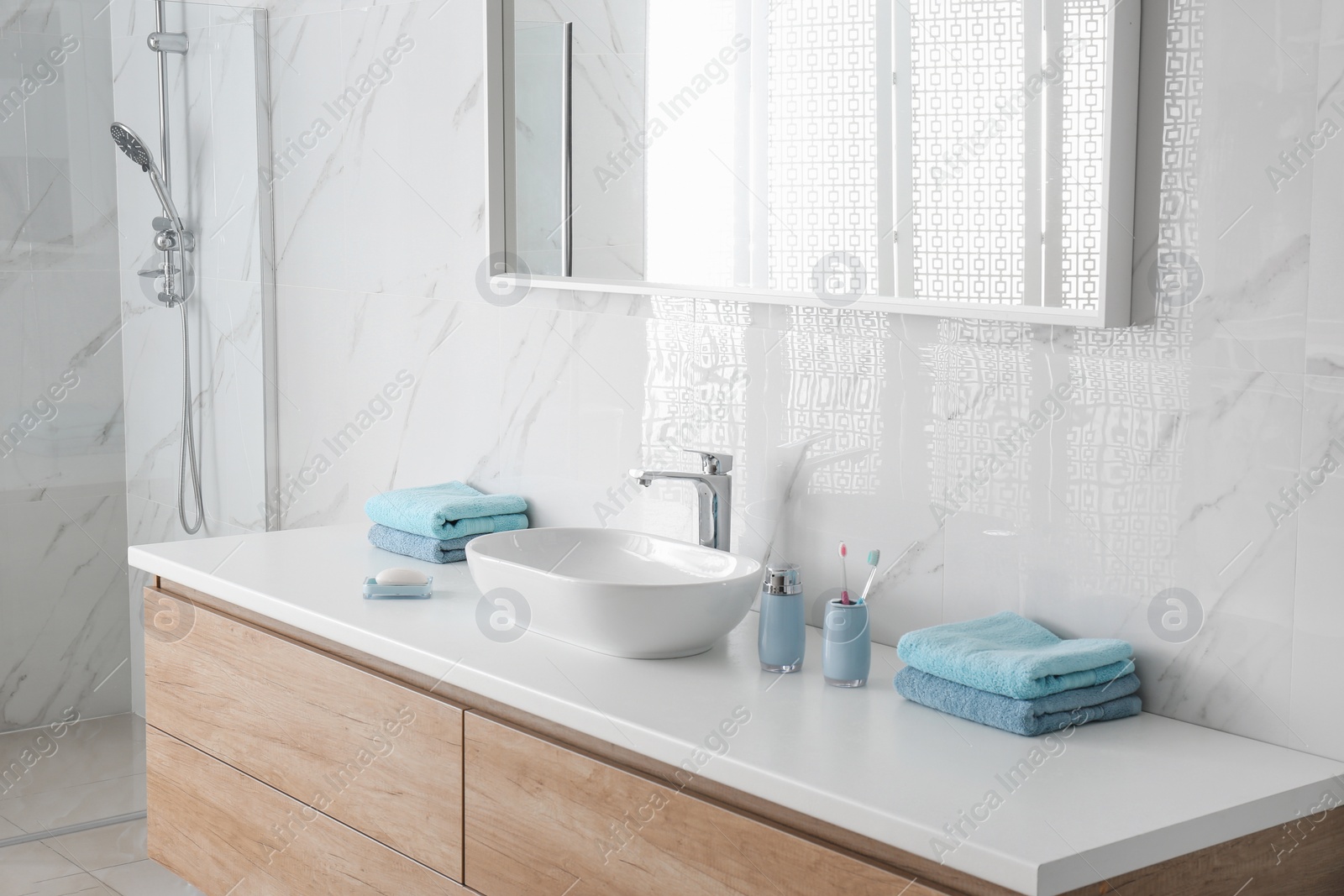 Photo of Modern mirror and vessel sink in stylish bathroom