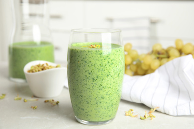 Photo of Green buckwheat smoothie on light grey marble table