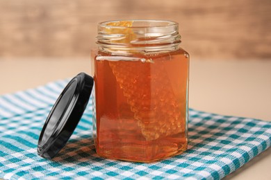 Photo of Jar with honey and combs on light table