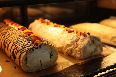 Delicious cake and meringue rolls on counter in bakery shop, closeup