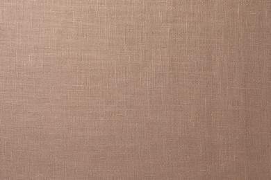 Photo of Texture of brown fabric as background, top view