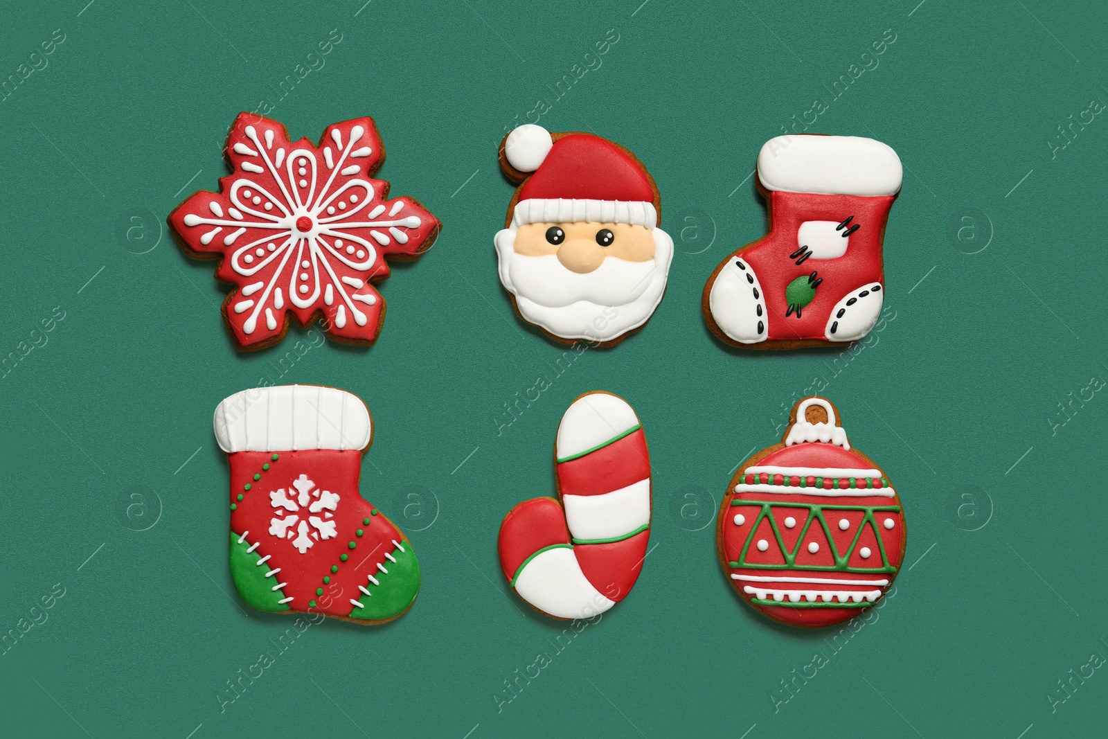 Photo of Different tasty Christmas cookies on green background, flat lay