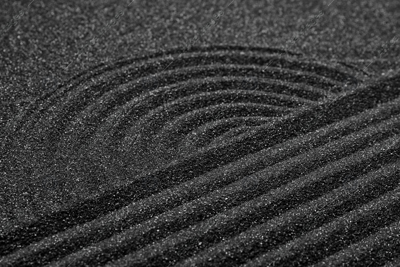 Photo of Closeup view of beautiful black sand. Zen and harmony