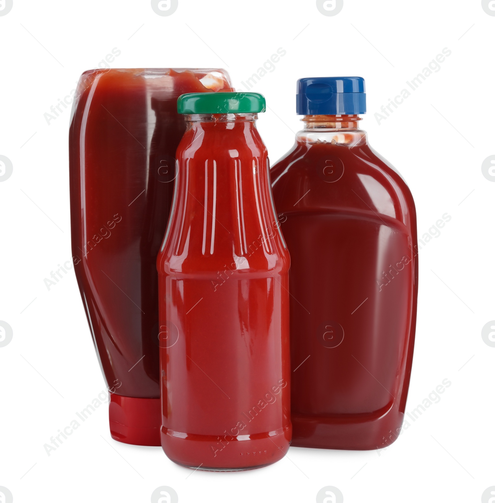 Photo of Different bottles of ketchup on white background