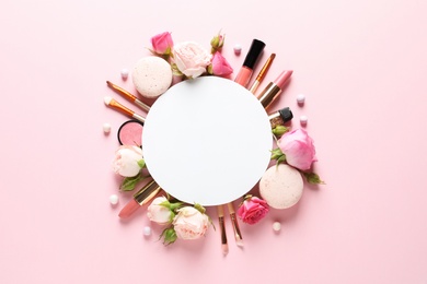 Photo of Flat lay composition with card and products for decorative makeup on pastel pink background