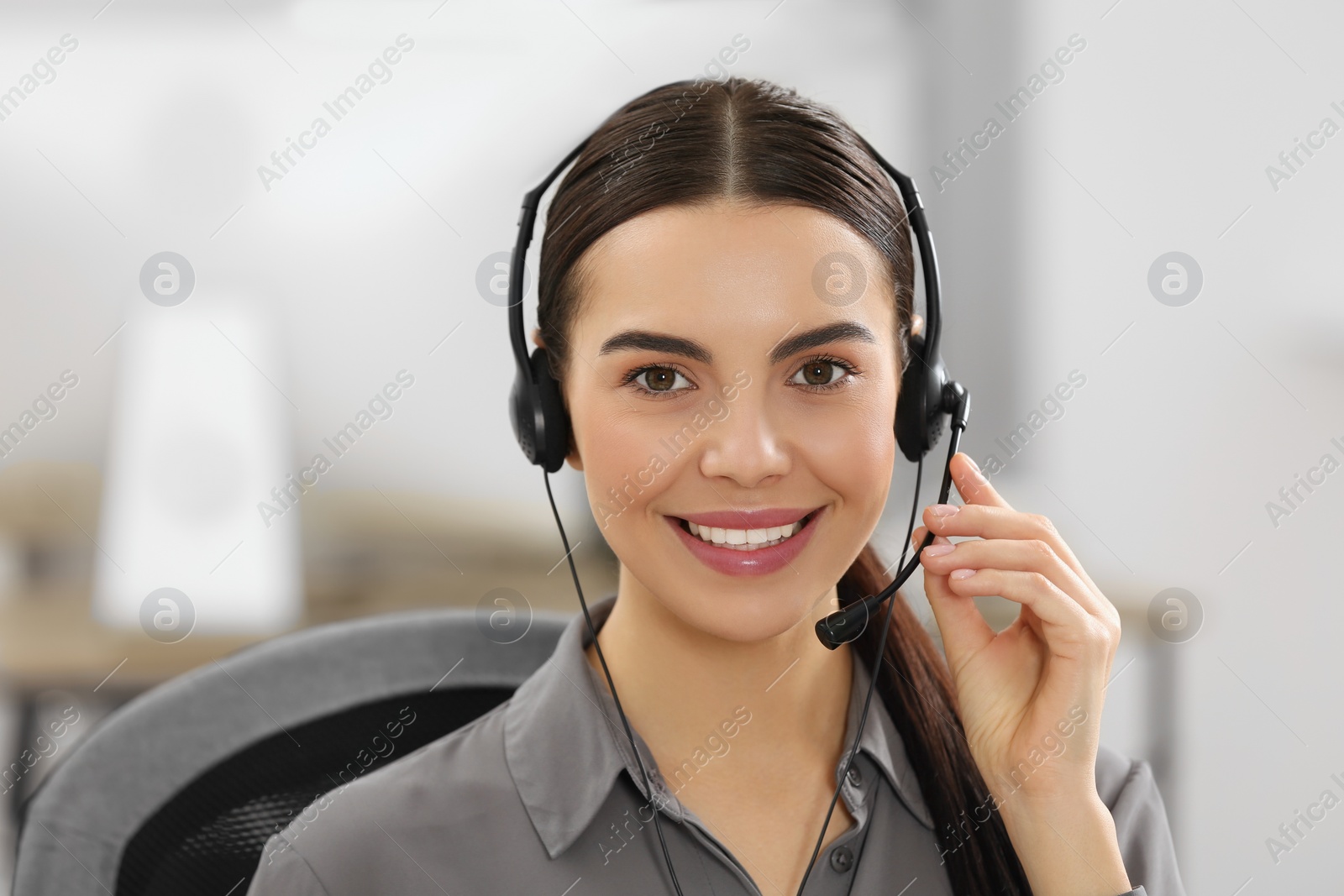 Photo of Hotline operator with headset working in office