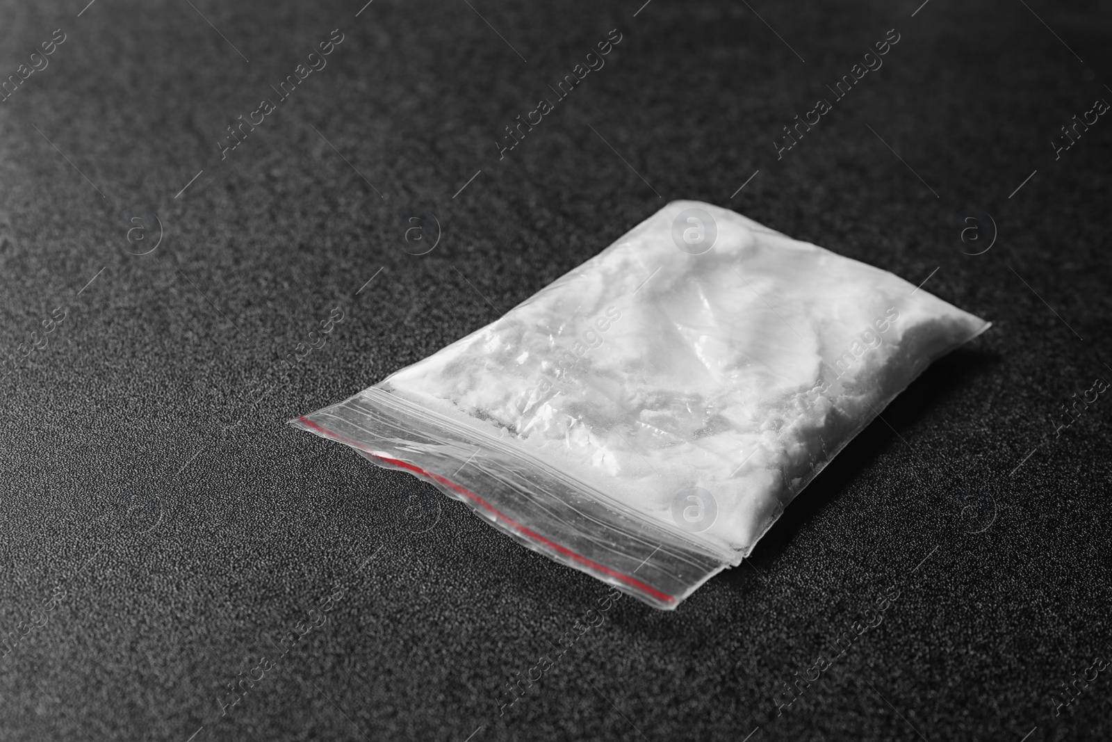 Photo of Cocaine in plastic bag on black background