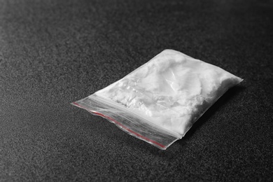 Photo of Cocaine in plastic bag on black background